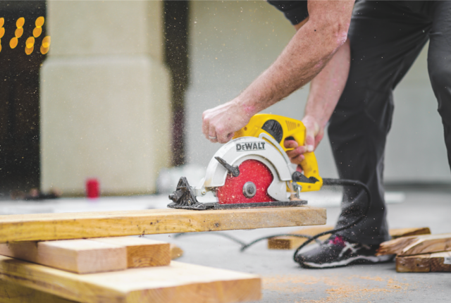 Image of carpenter cutting wood.