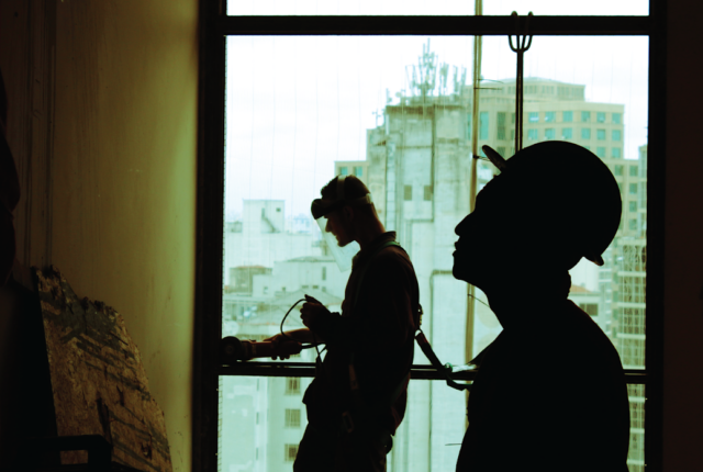 image of construction workers building an apartment block