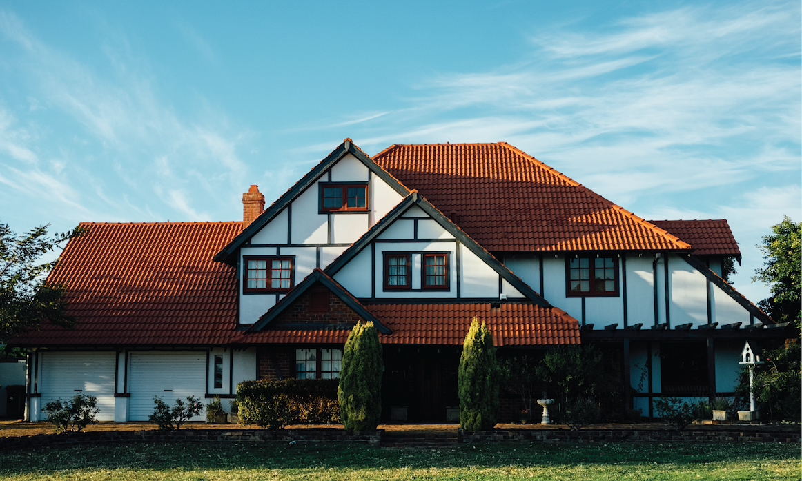 Image of a self build house. House is in the traditional black and with revival architecture style with a modern look and feel.